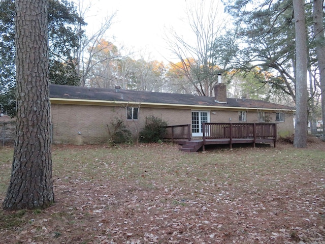 back of house with a deck