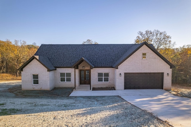 view of front of home with french doors and a garage