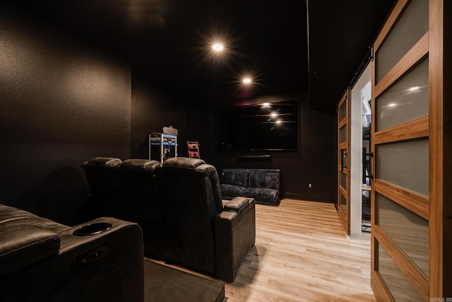 cinema featuring light hardwood / wood-style floors