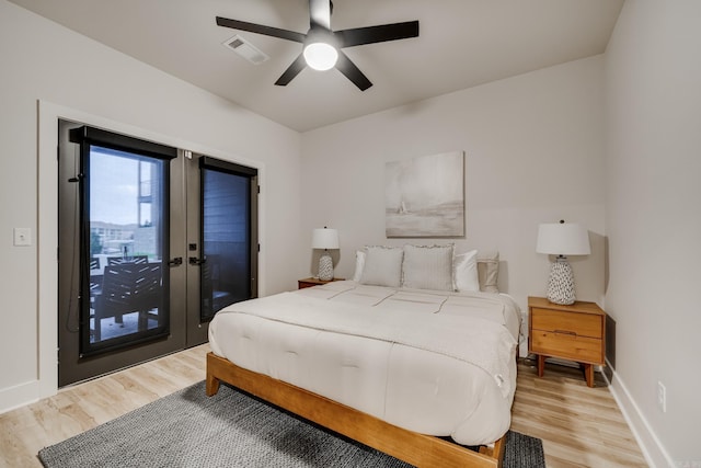 bedroom with light wood-type flooring, access to outside, and ceiling fan