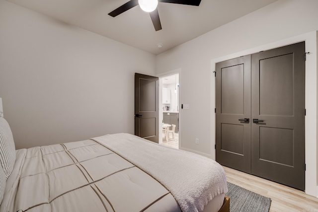 bedroom with ceiling fan, a closet, and light hardwood / wood-style floors