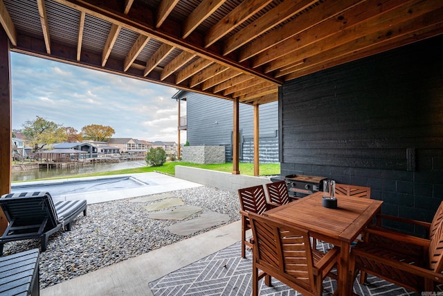 view of patio / terrace featuring a swimming pool and a water view