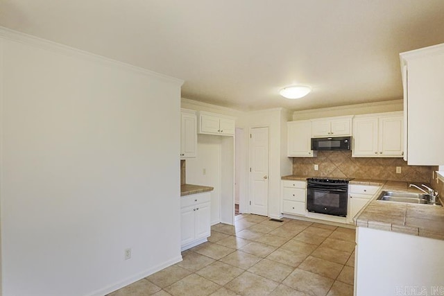 kitchen with sink, white cabinets, black appliances, and ornamental molding