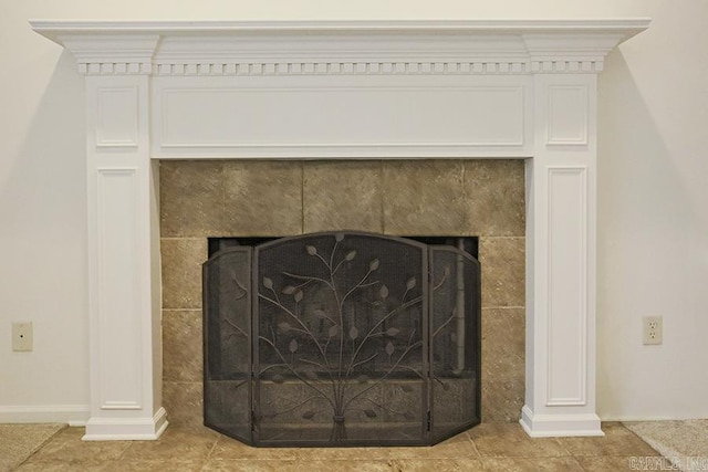 room details featuring a tile fireplace