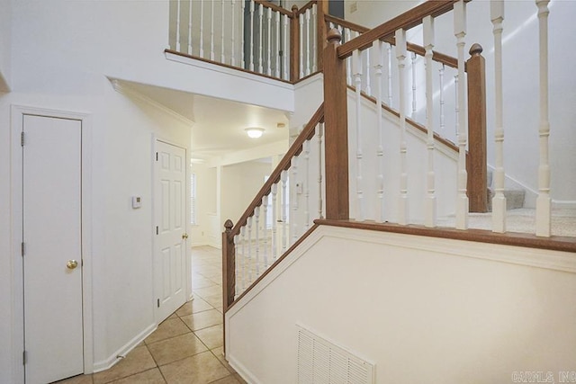 stairs featuring tile patterned floors