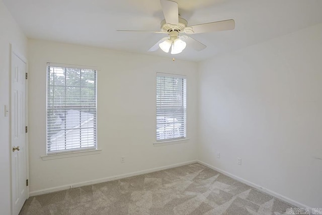 unfurnished room featuring ceiling fan and light colored carpet