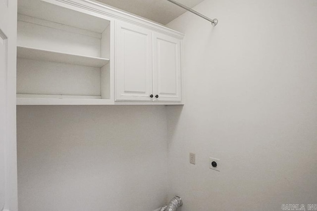 laundry room with electric dryer hookup and cabinets