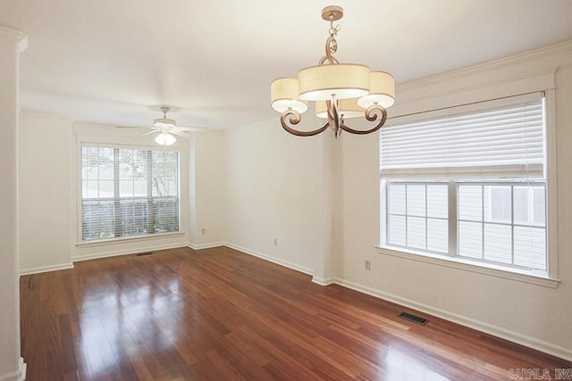 unfurnished room with ceiling fan with notable chandelier and dark hardwood / wood-style floors