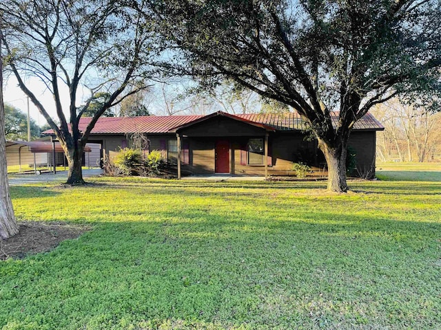 ranch-style house featuring a front yard and a carport