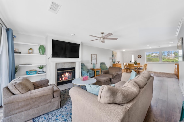 living room with ceiling fan, light hardwood / wood-style floors, and ornamental molding