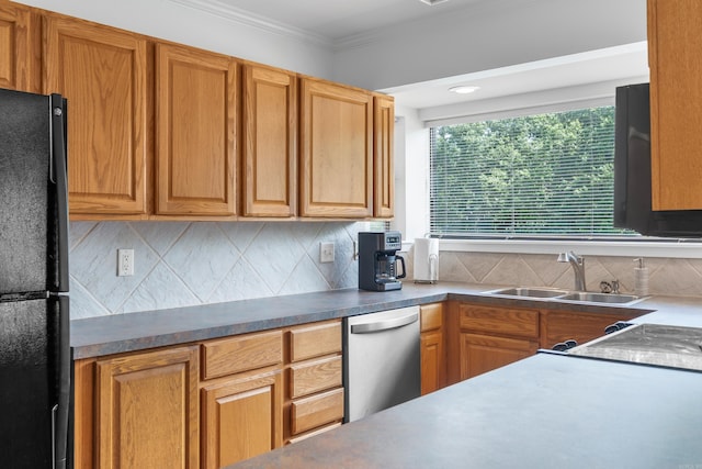 kitchen with black refrigerator, crown molding, sink, stainless steel dishwasher, and decorative backsplash