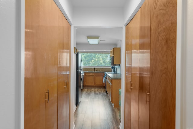 hallway with light hardwood / wood-style flooring