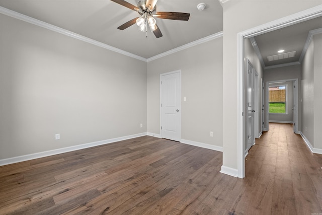 empty room featuring ceiling fan, dark wood-type flooring, and ornamental molding