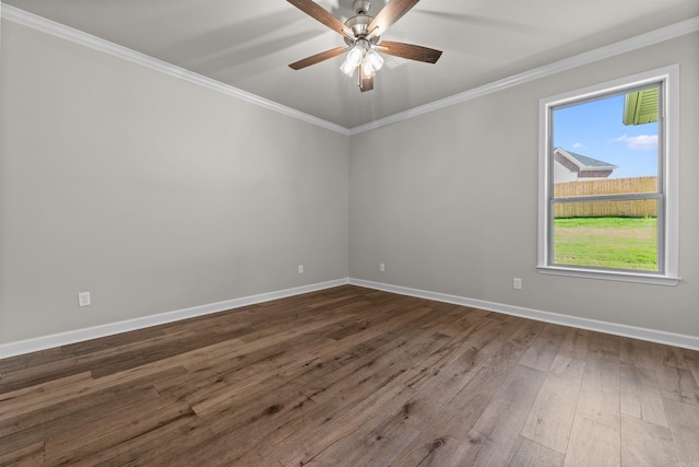 spare room featuring crown molding, ceiling fan, and dark wood-type flooring