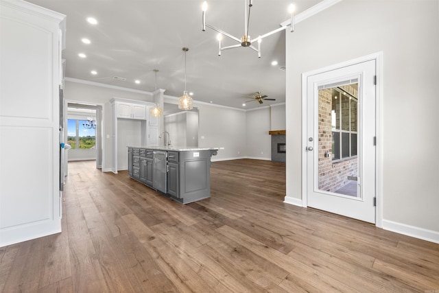 kitchen with pendant lighting, ceiling fan, gray cabinets, an island with sink, and white cabinetry