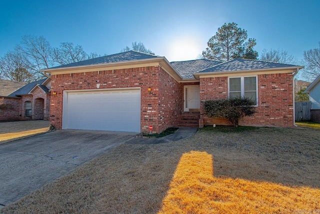 ranch-style home featuring a garage and a front lawn