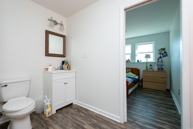 bathroom featuring wood-type flooring, vanity, and toilet