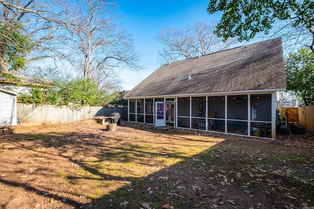 back of property with a sunroom