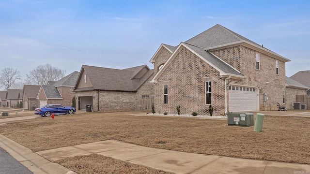 view of side of property with central AC and a garage