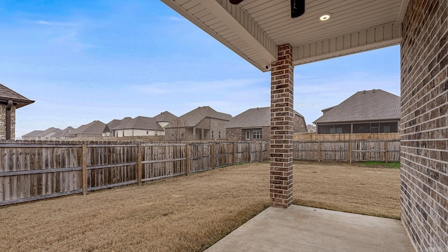 view of yard with ceiling fan and a patio area