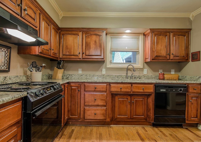 kitchen featuring black appliances, light stone countertops, sink, and ornamental molding