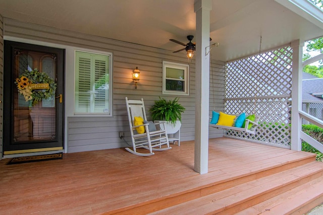 wooden deck with ceiling fan and covered porch