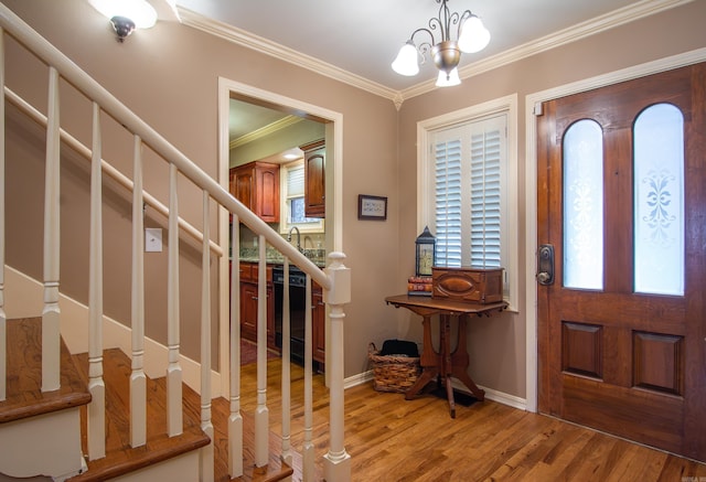 entryway featuring hardwood / wood-style floors, a notable chandelier, and ornamental molding