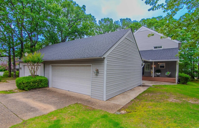 view of home's exterior featuring a lawn, a porch, and a garage