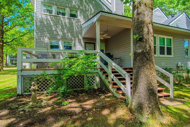 back of property with ceiling fan and a deck