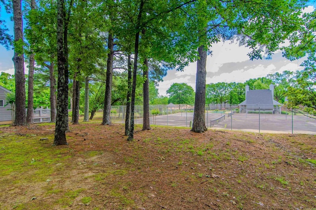 view of yard featuring tennis court