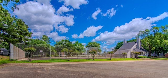 view of property's community featuring tennis court