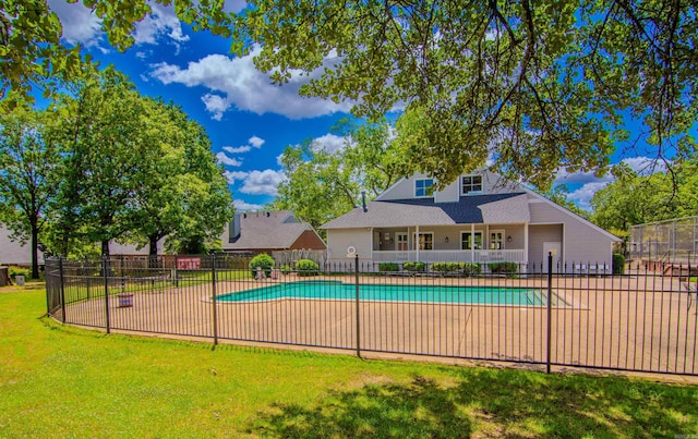 view of swimming pool with a yard and a patio