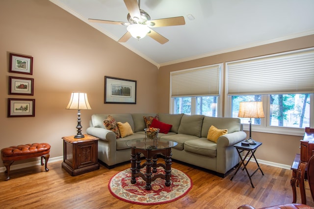 living room featuring light hardwood / wood-style flooring, vaulted ceiling, ceiling fan, and ornamental molding