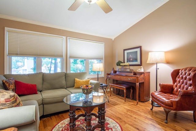 living room featuring ceiling fan, lofted ceiling, ornamental molding, and light hardwood / wood-style flooring