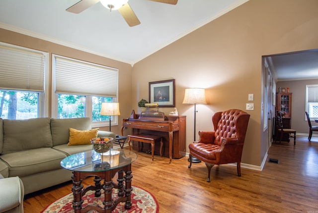 living room with hardwood / wood-style floors, ceiling fan, lofted ceiling, and ornamental molding