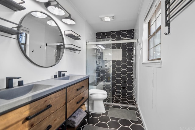 bathroom with tile patterned flooring, vanity, toilet, and a shower with door