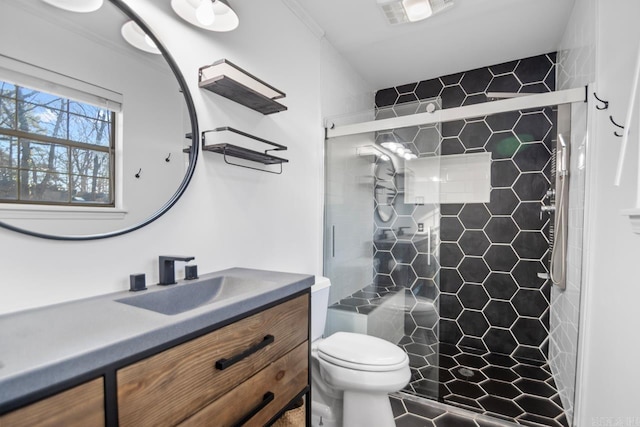 bathroom with vanity, toilet, and a shower with shower door