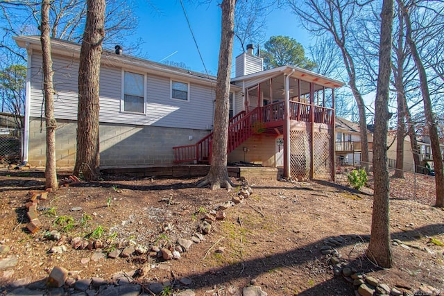 rear view of house with a wooden deck