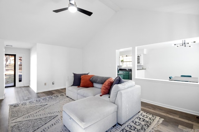 living room featuring beamed ceiling, ceiling fan, dark hardwood / wood-style flooring, and sink