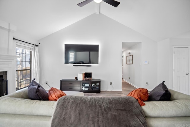 living room with vaulted ceiling with beams, dark hardwood / wood-style flooring, and ceiling fan