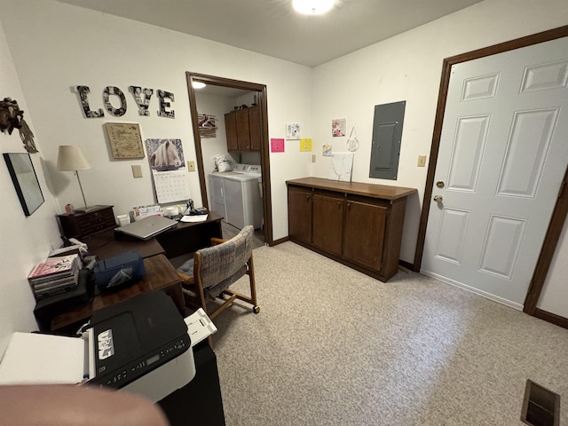 carpeted office space featuring electric panel and washing machine and clothes dryer