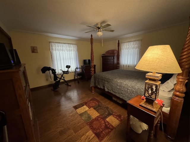 bedroom featuring dark hardwood / wood-style flooring, ceiling fan, and crown molding