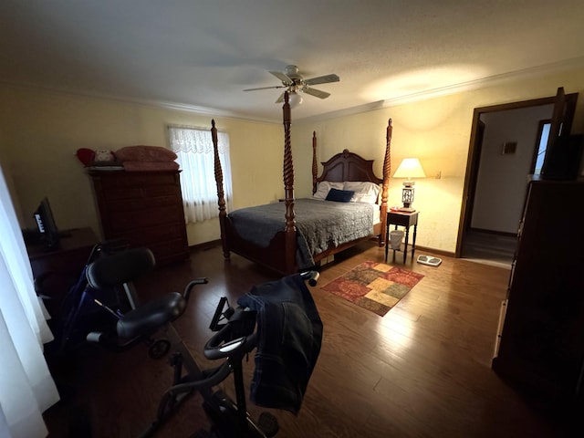 bedroom with ceiling fan, dark hardwood / wood-style floors, and crown molding