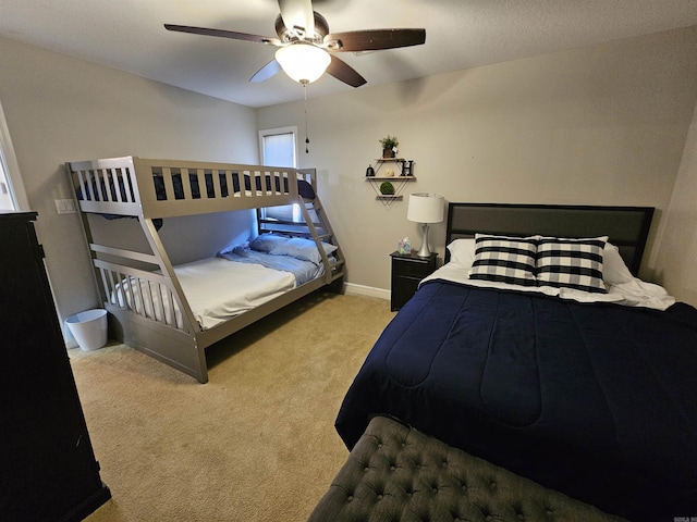 bedroom with ceiling fan and light carpet