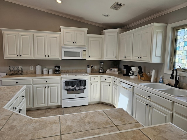 kitchen featuring white cabinets, white appliances, lofted ceiling, and sink