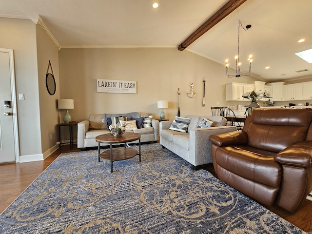 living room featuring dark hardwood / wood-style flooring, lofted ceiling with beams, an inviting chandelier, and ornamental molding