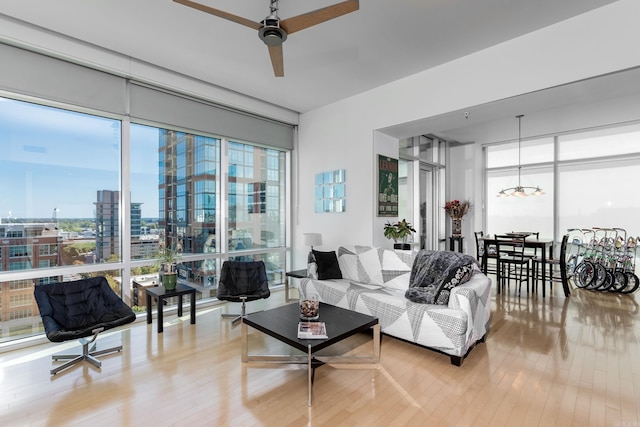 living room featuring wood-type flooring and ceiling fan