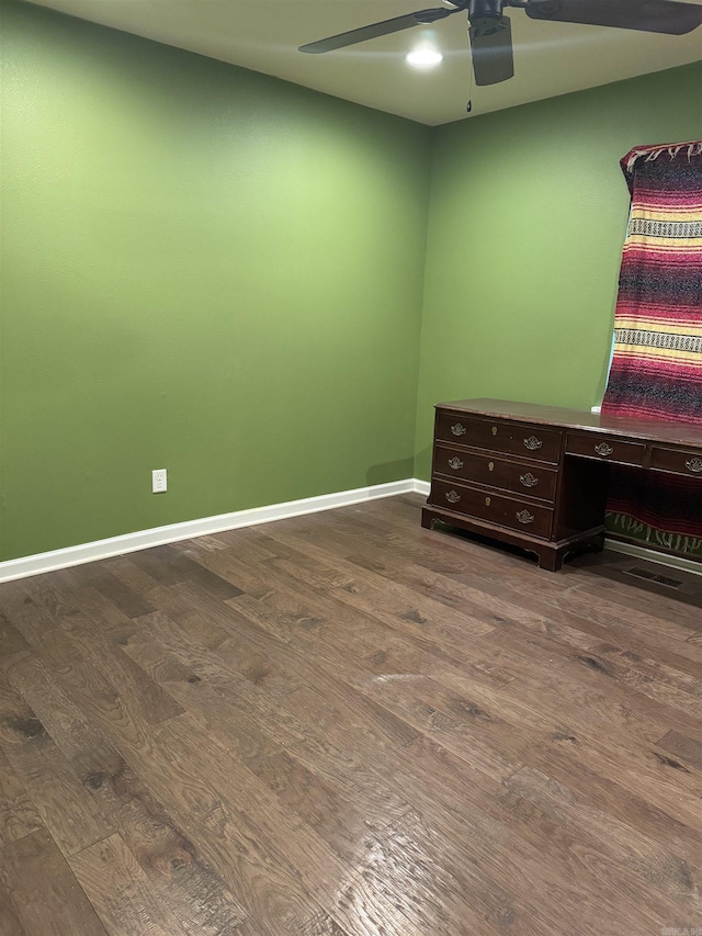 unfurnished bedroom with ceiling fan and dark hardwood / wood-style flooring