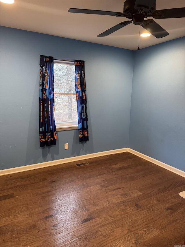 empty room featuring ceiling fan and hardwood / wood-style flooring