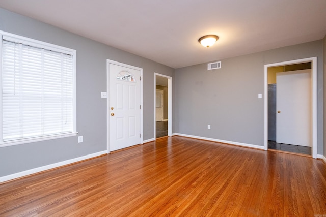 unfurnished room with hardwood / wood-style floors